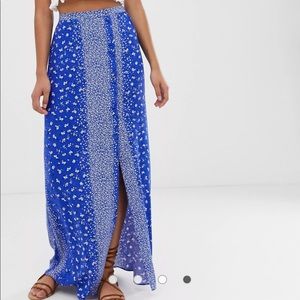 ASOS DESIGN crinkle maxi skirt with self covered buttons in blue floral print